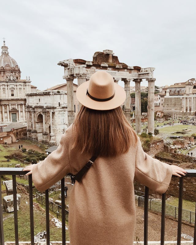 a woman admiring a view over the Roman Forum in Rome.